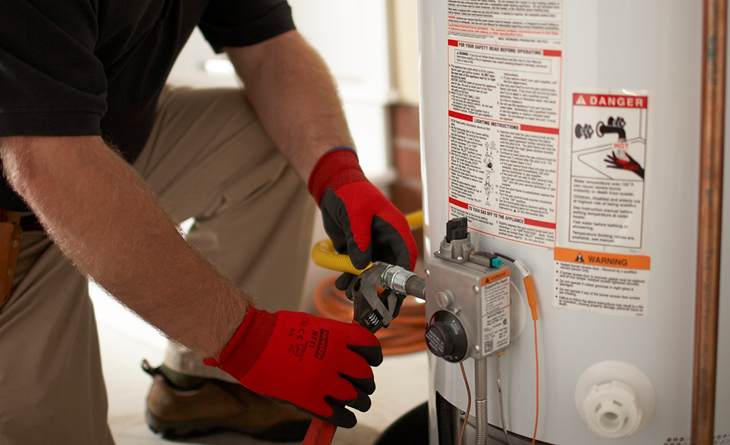 man installing a water heater