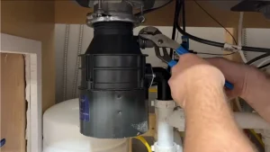 Fixing garbage disposal by plumber