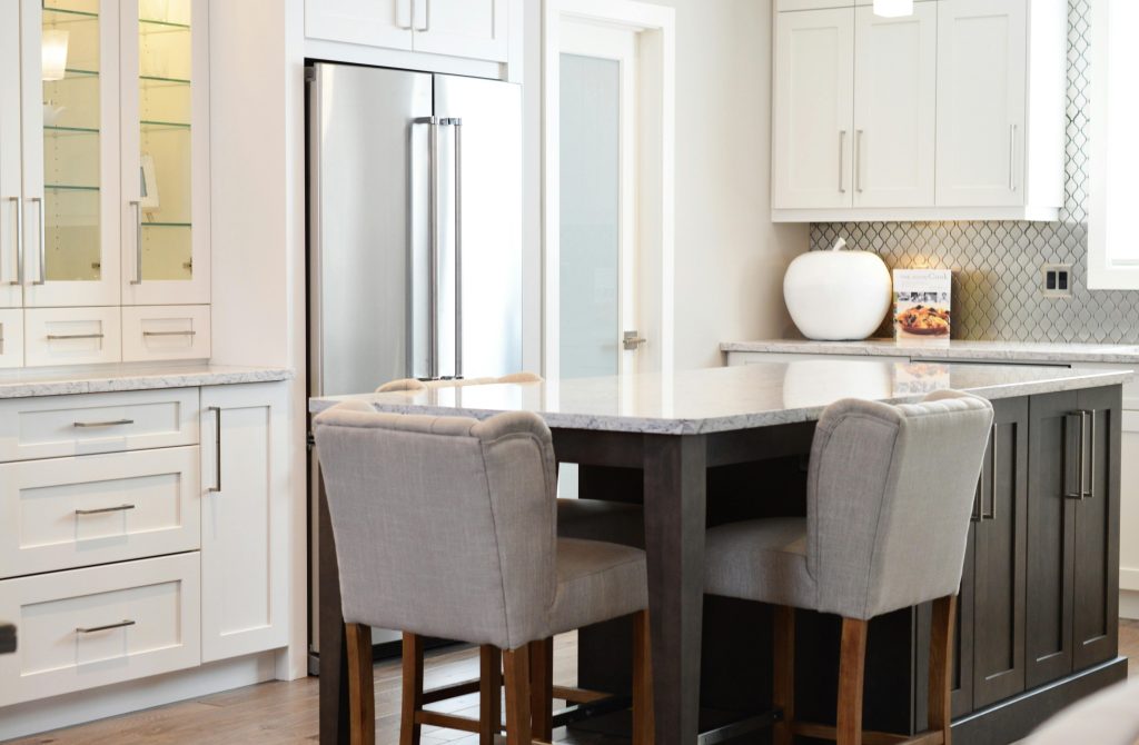 kitchen remodel with white cabinets and glass shelves