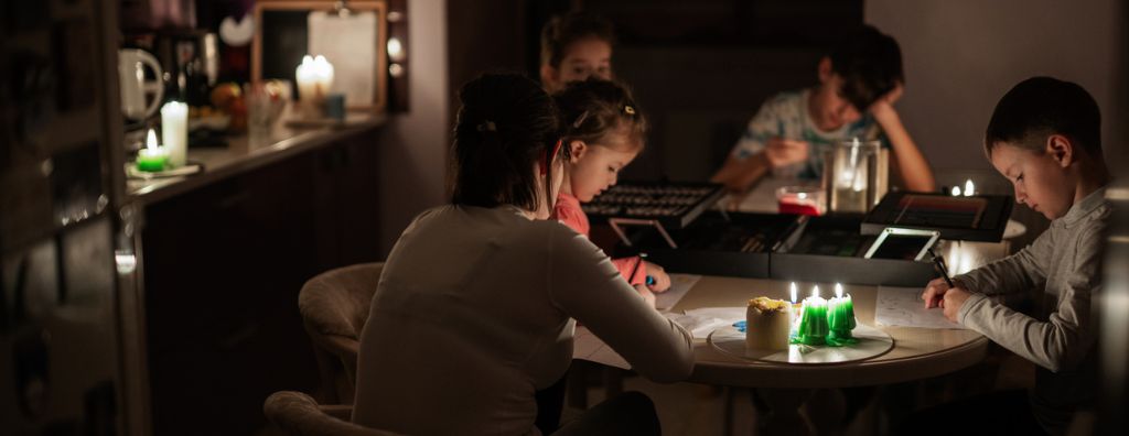 family using candles during power outage